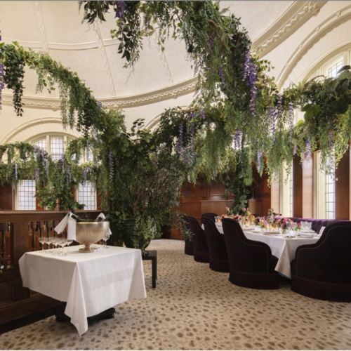indoor wedding dining event space with foliage
