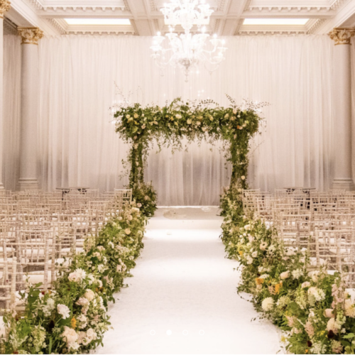 Wedding ceremony event space decorated with flower arrangements