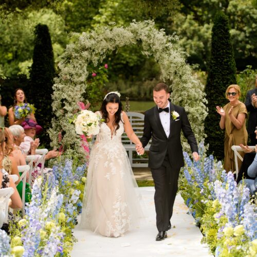 A newly married couple walking down the aisle.