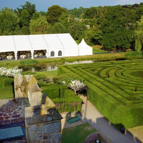 A view of the gardens and maze with tent used for outdoor wedding venue space